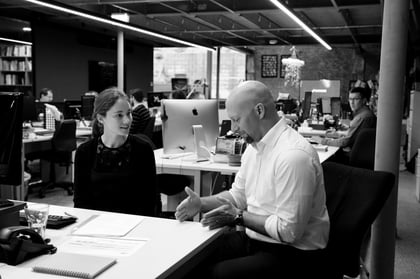Mike and claire talking at desks
