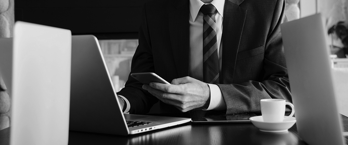 businessman on his phone drinking a coffee