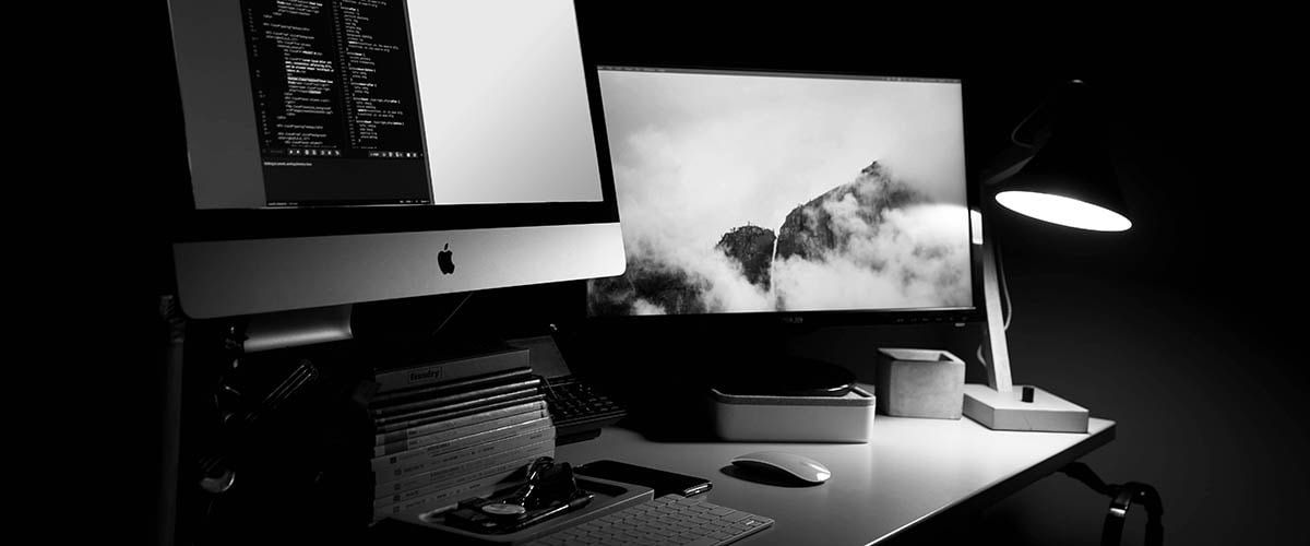 Bespoke vs enterprise computer screens on a desk