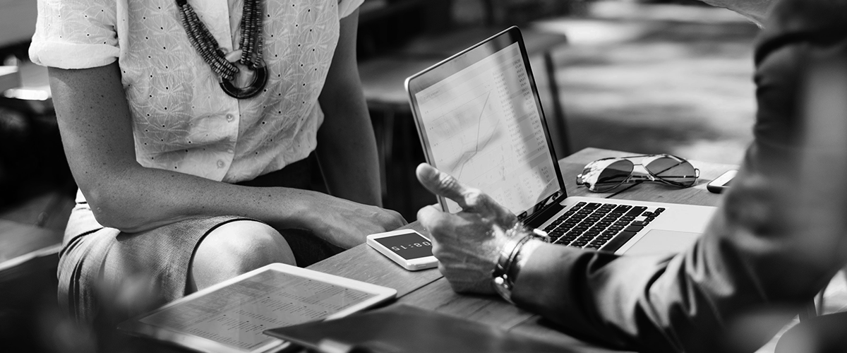 Market research man and woman talking over laptop