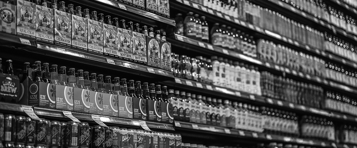 category managers bottles on a shelf at supermarket