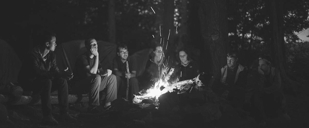 people sitting around a campfire telling stories